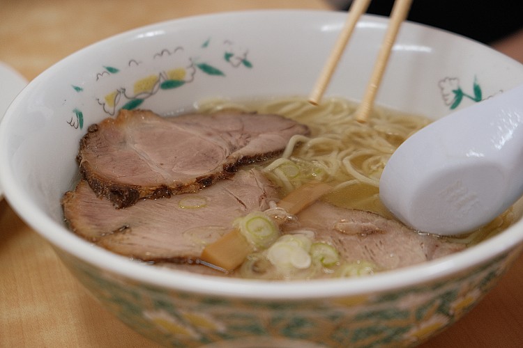 湯頭清澈透亮，入口先感受到淡淡鹽香，緊接著雞骨、昆布與蔬菜的旨味層層釋放。少了厚重油脂的覆蓋，整體風味乾淨、深邃而平衡，體現職人對火候與比例的極致掌握。