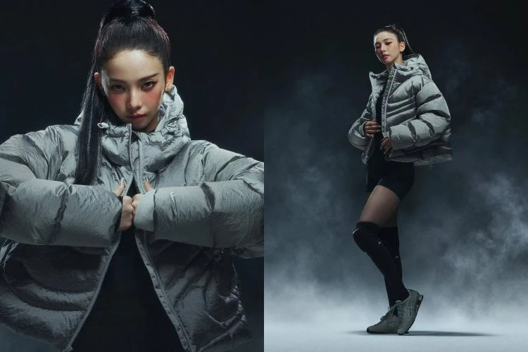Karina穿上的是Nike灰色羽絨短版外套，以霧面灰色呈現，線條俐落、澎度集中在肩線與手臂，讓外套本身就帶有力量感。
