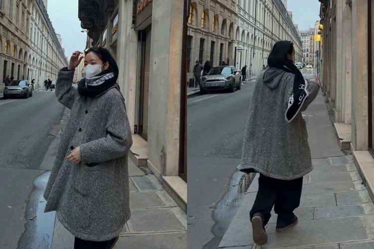 金高銀身穿灰色人字紋中長版大衣線條筆直，長度落在膝下，比例收得剛好，不刻意強調身形，卻自然顯瘦。她選擇全身低彩度搭配，黑色內搭與褲裝把視覺重心壓低，讓外套的紋理成為主角。
