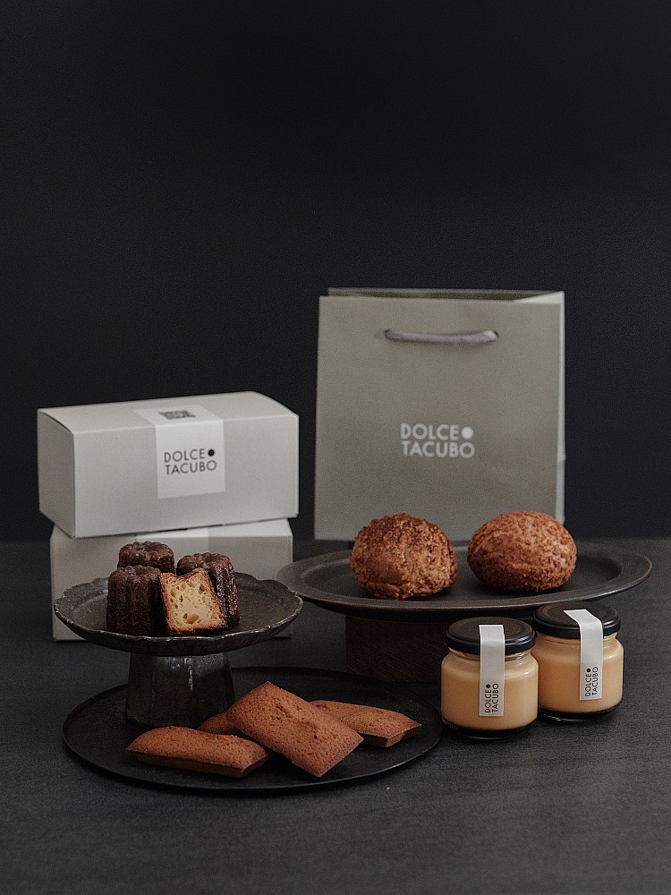 其中最受矚目的「Dolce Gourmand Box 極致品味四重奏」集結四款經典：現烤費南雪、法式可麗露、焦糖布丁與卡士達泡芙，一次品味四種層次的香氣與口感