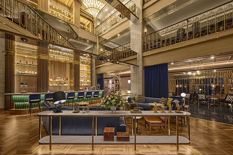 大廳像是一座被金色點亮的劇場，三層樓挑高在踏進來的瞬間就把旅人包進一場華麗的表演之中。