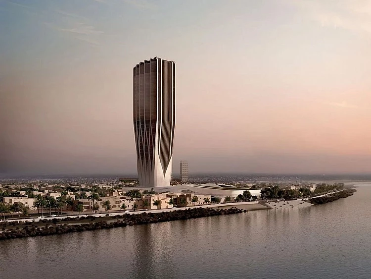 伊拉克中央銀行的新總部,對札哈・哈蒂(Zaha Hadid)而言,是一場帶著苦澀意味的「返鄉」。這是這位已故英籍伊拉克裔建築師,在家鄉首都巴格達(Baghdad)唯一落成的建築。儘管她親自主持了最初於 2011 年公布的設計,卻在五年後英年早逝,未能等到工程動土。如今,這座高樓拔地而起,宛如一只香檳杯,改寫天際線,極具震撼力。