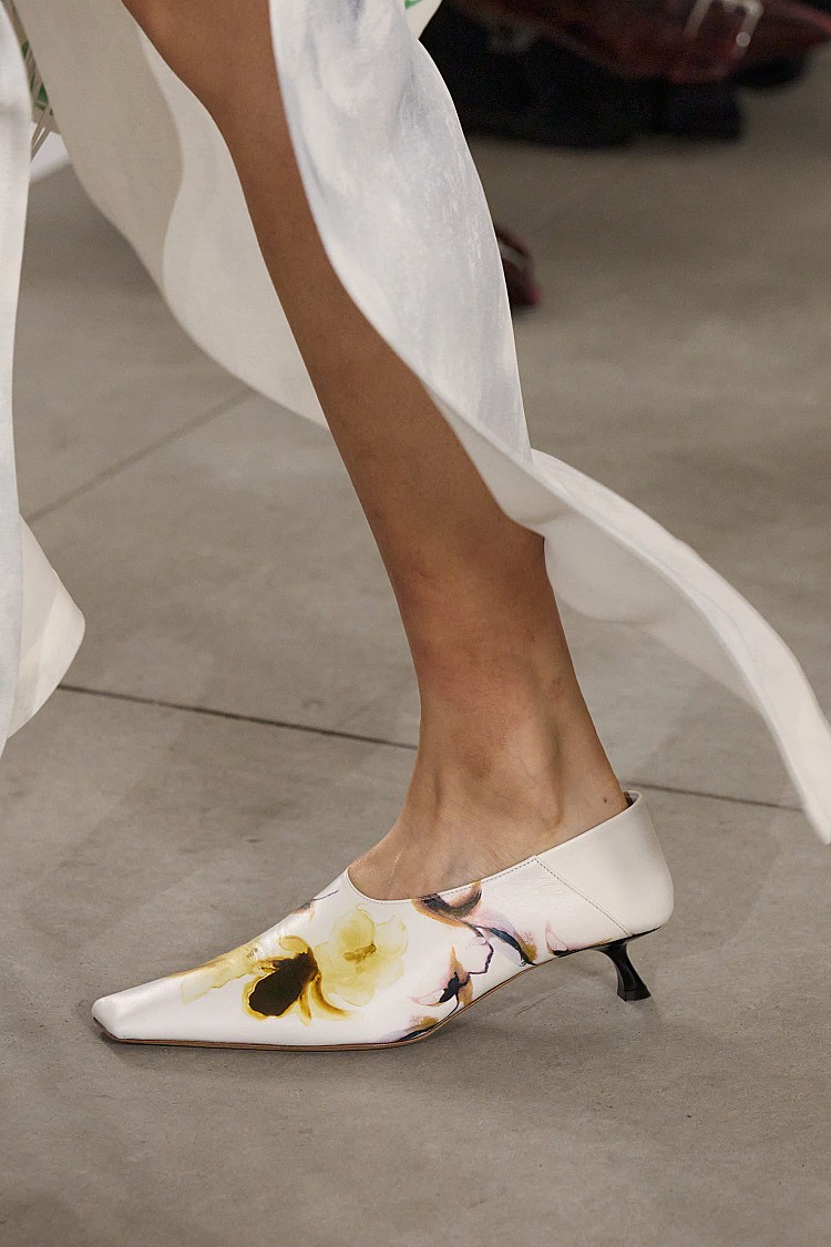 鞋履部分,Sportmax本季以「行動的優雅」為題,推出兼具實用與時髦的低跟穆勒鞋。延伸自品牌經典貓跟輪廓,搭配順滑皮革與金屬光澤細節,展現都會女性日常中也能駕馭的摩登風範。