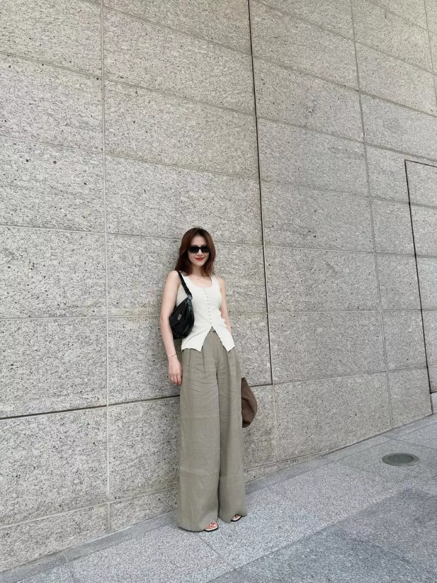 走在城市街頭,高圓圓選擇淺米色針織背心搭配卡其寬褲,乾淨俐落。這一身雖然沒有華麗設計,但墨鏡和黑色肩背包立刻把休閒感拉高到都會時髦的層次。她的秘訣就在於「用配件定義風格」,即使服裝是基礎款,也能透過墨鏡和包包塑造強大氣場。