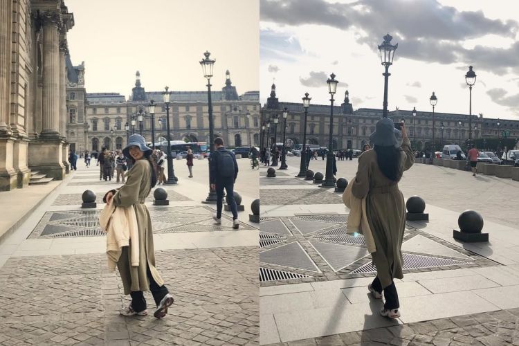 這套街頭造型中，金高銀選擇帶有自然垂墜感的卡其色長版大衣，輪廓寬鬆卻不鬆散，關鍵在腰間自然形成的收束比例，讓視覺重心穩穩落在身體中央。