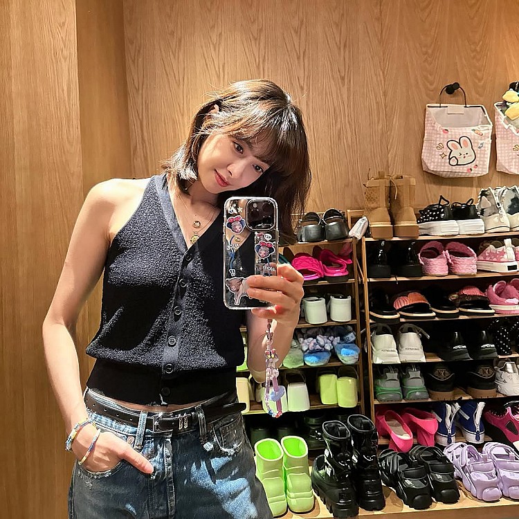 透過上窄下寬比例做出顯瘦的效果，是宋茜拿手的穿搭公式。這套選擇黑色短版針織背心作為上身主角，V領與釦子線條拉出優雅鎖骨與肩頸，非常適合想營造精緻小臉與修長上半身的時髦女子們。