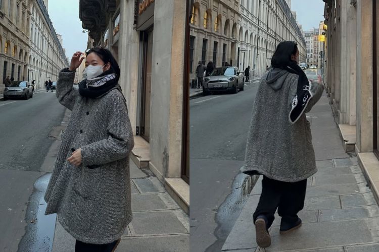 金高銀身穿灰色人字紋中長版大衣線條筆直，長度落在膝下，比例收得剛好，不刻意強調身形，卻自然顯瘦。她選擇全身低彩度搭配，黑色內搭與褲裝把視覺重心壓低，讓外套的紋理成為主角。