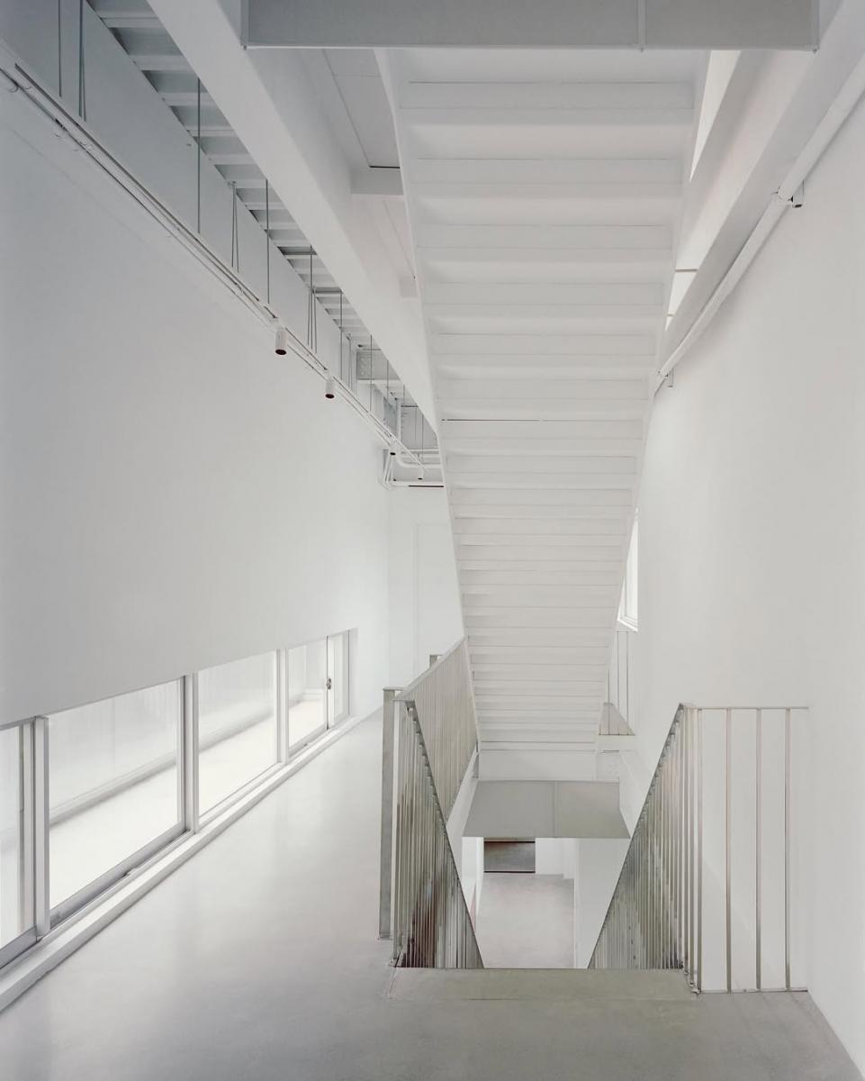 在空間彩度上，並未做出太多鮮豔的轉譯。弱化彩度，成為兩位建築師一致的共同理念。極簡的純白語彙，降低倉庫和辦公空間很容易讓人感到雜亂的可能性。