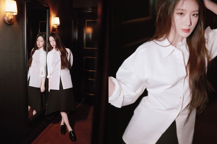 舒華以一件俐落的白襯衫作為主角，捲起的袖口展現不經意的隨性感，搭配深色不對稱裙 拉出層次與結構感，讓整體造型更具立體氛圍。