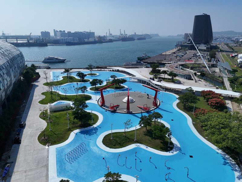 高雄亞灣區再添新地標!位於前鎮的新建案「星光水岸公園」即將完工,預計明年夏天正式開幕,未來將成為高雄最大的水上樂園。此次針對現有星光水岸公園進行擴建,不同於原先僅占公園面積 5% 的戲水區,將一舉擴大至整座 8,000 多坪的公園範圍,打造全新的親水空間。園區透過大量綠意植栽、戲水池與休憩設施,為當地注入嶄新活力。透過高雄環狀輕軌串連,更可連接高雄港旅運中心及駁二藝術特區,成為市區休閒與觀光的熱門節點。