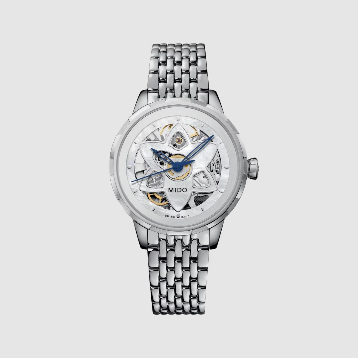 Mido 將「時間」化作花朵盛開的瞬間。Rainflower Blossom 花雨腕錶是品牌首款專為女性打造的鏤空腕錶，靈感來自新加坡藝術科學博物館的蓮花造型建築。珍珠母貝錶盤的鏤空花瓣圖案若隱若現，讓人彷彿窺見機芯律動。搭載 Caliber 80 自動機芯，動力儲存達80小時，媲美高階錶款。這是一只結合女性柔美與機械靈魂的作品，在浪漫外表下，藏著精密結構的堅定，是送給獨立女性最動人的禮物。