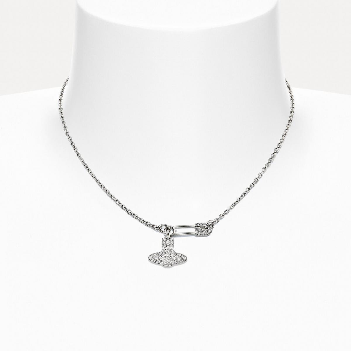 Vivienne Westwood 的 Lucrece 頸鍊，結合安全別針造型與經典土星吊飾，滿載叛逆精神。銀色調水晶閃爍間透出搖滾與浪漫的衝突張力，是每位獨立女性的宣言配件。戴上它，不只是裝飾，更像為日常注入一劑態度。搭配西裝外套或素色T恤，都能瞬間強化個人風格，展現「高級龐克」的無畏魅力。