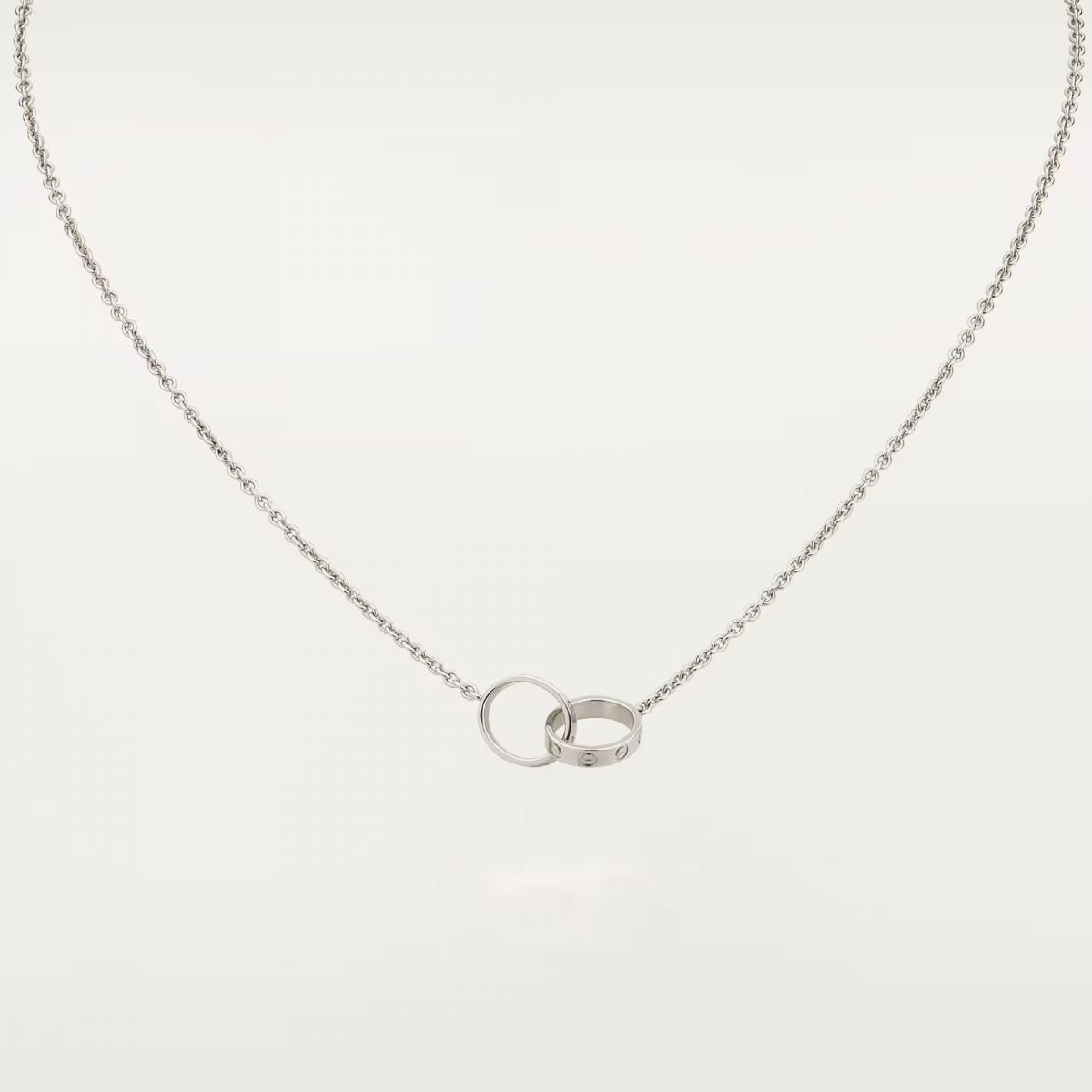 Cartier 的 Love 系列自1970年代問世以來，一直是愛與承諾的代名詞，而這款以兩枚 Love 圓環相扣而成的18K白金吊墜，更像是一段關係的縮影。標誌性的螺絲紋象徵兩人之間牢不可破的連結；圓潤線條則展現卡地亞一貫的優雅克制。它沒有高調的光芒，卻擁有穿越日常的耐看度——搭配襯衫時是氣質的點綴，配上禮服又能自然融入光線，彷彿一種陪伴感在胸口靜靜呼吸。Love 項鍊真正迷人之處，在於它不只是配件，而是一份可被「佩戴」的態度：純粹、堅定、且願意長久存在。