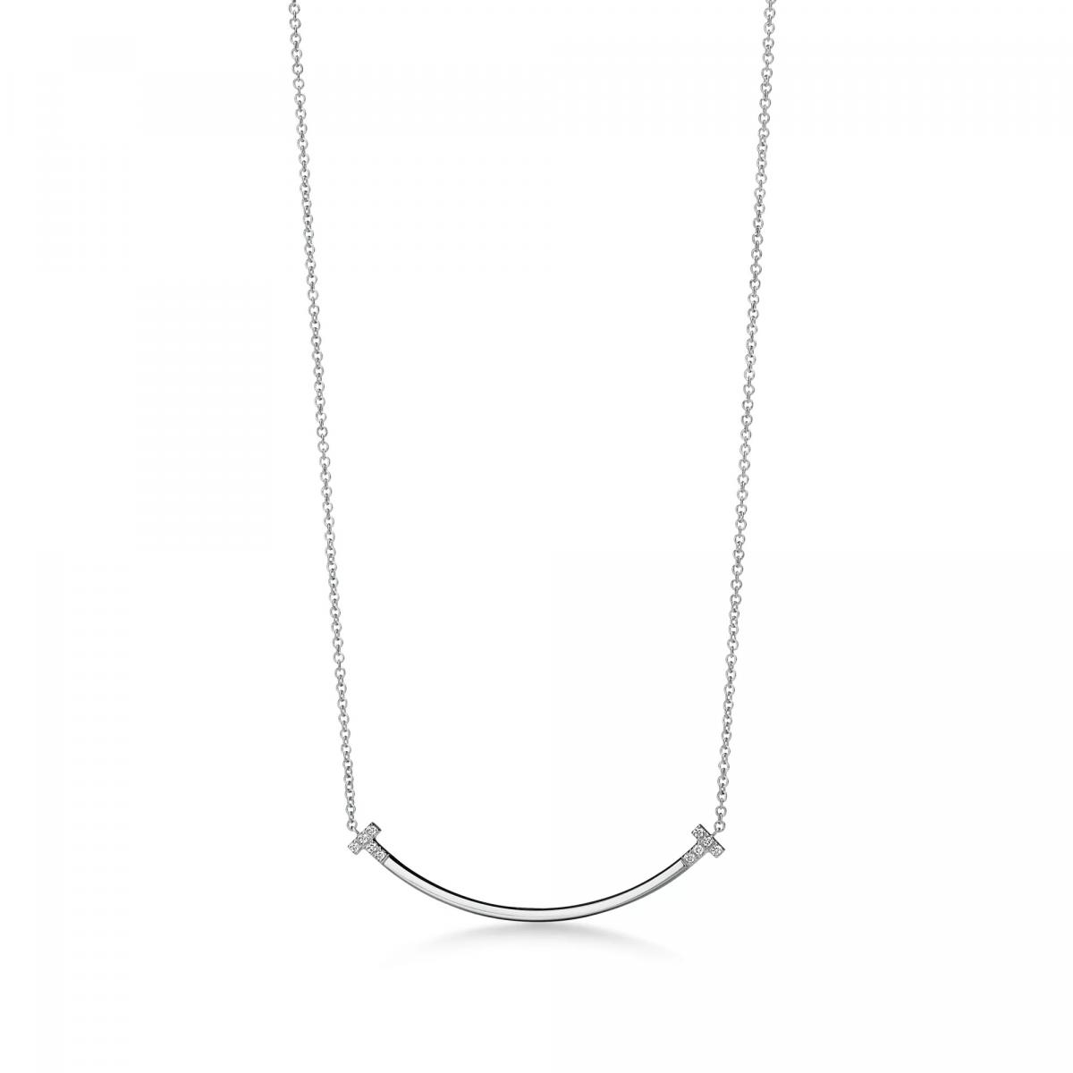 Tiffany T 系列向來象徵紐約的直率與能量，而 T Smile 更是在嚴謹線條中藏入一抹柔和的情緒。這款18K白金小號項鍊由一條流暢的微笑弧線構成，鑲嵌約0.03克拉鑽石，使光芒像落在嘴角的亮點般自然。它的魅力不在於張揚，而是那種「有一點亮、但剛剛好」的優雅。微笑曲線搭配細緻鍊條，讓整體散發如同紐約街角般的輕鬆節奏——忙碌卻充滿希望。T 字作為品牌符碼，也寓意著方向、選擇與可能性，非常適合正走在新階段、給自己一份鼓勵的佩戴者。它是日常造型裡最容易融入的一抹光，毫不費力卻能讓氣質瞬間提升。